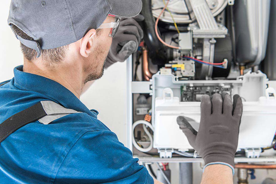 man repairing furnace