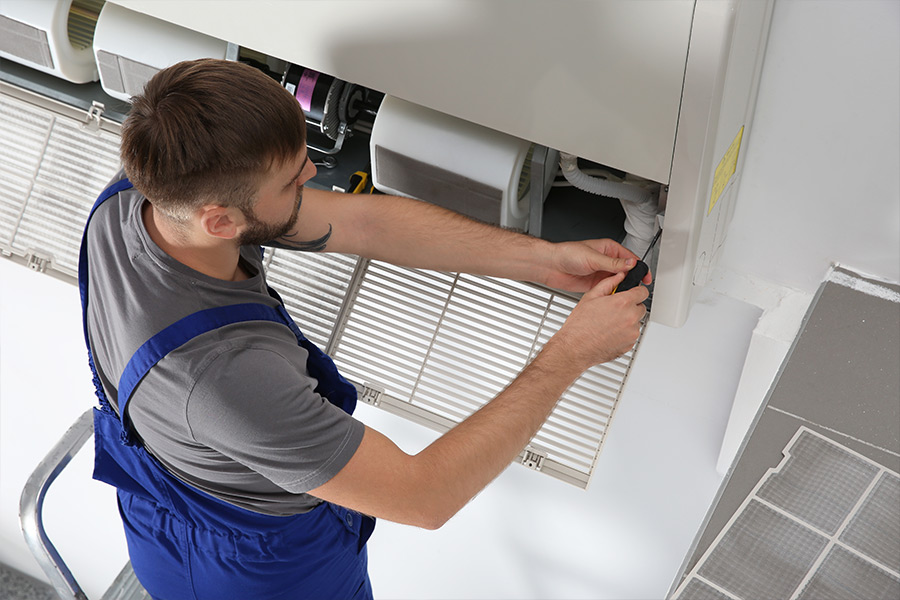 man replacing air conditioning