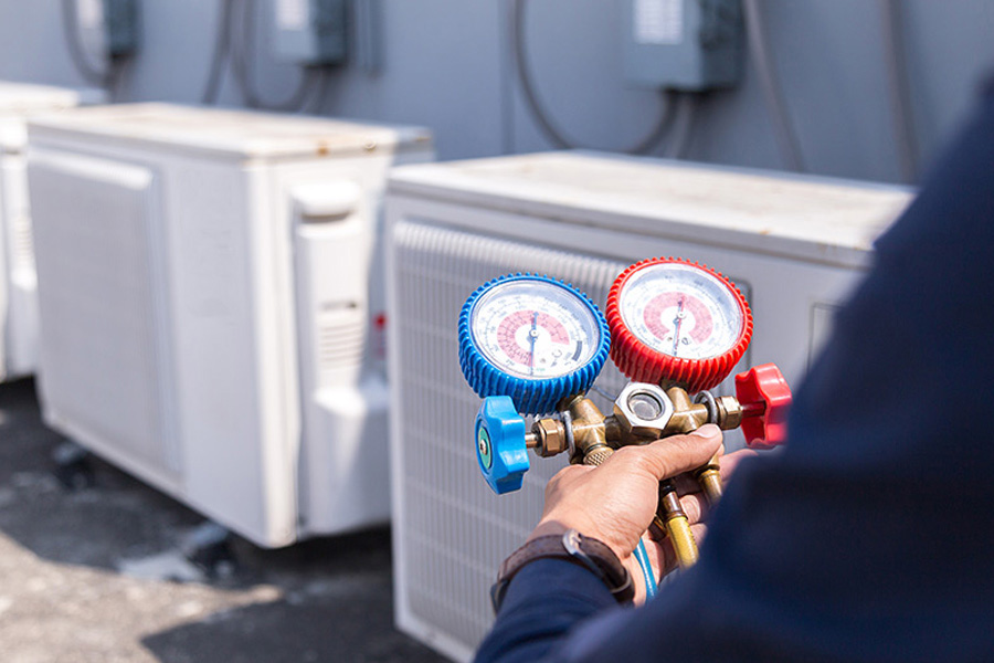 technician with regulator testing commercial hvac units